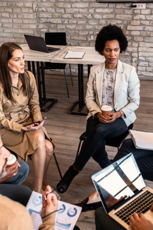 Group of diverse group of business people having a meeting while Group of diverse group of business people having a meeting while sitting in circle.